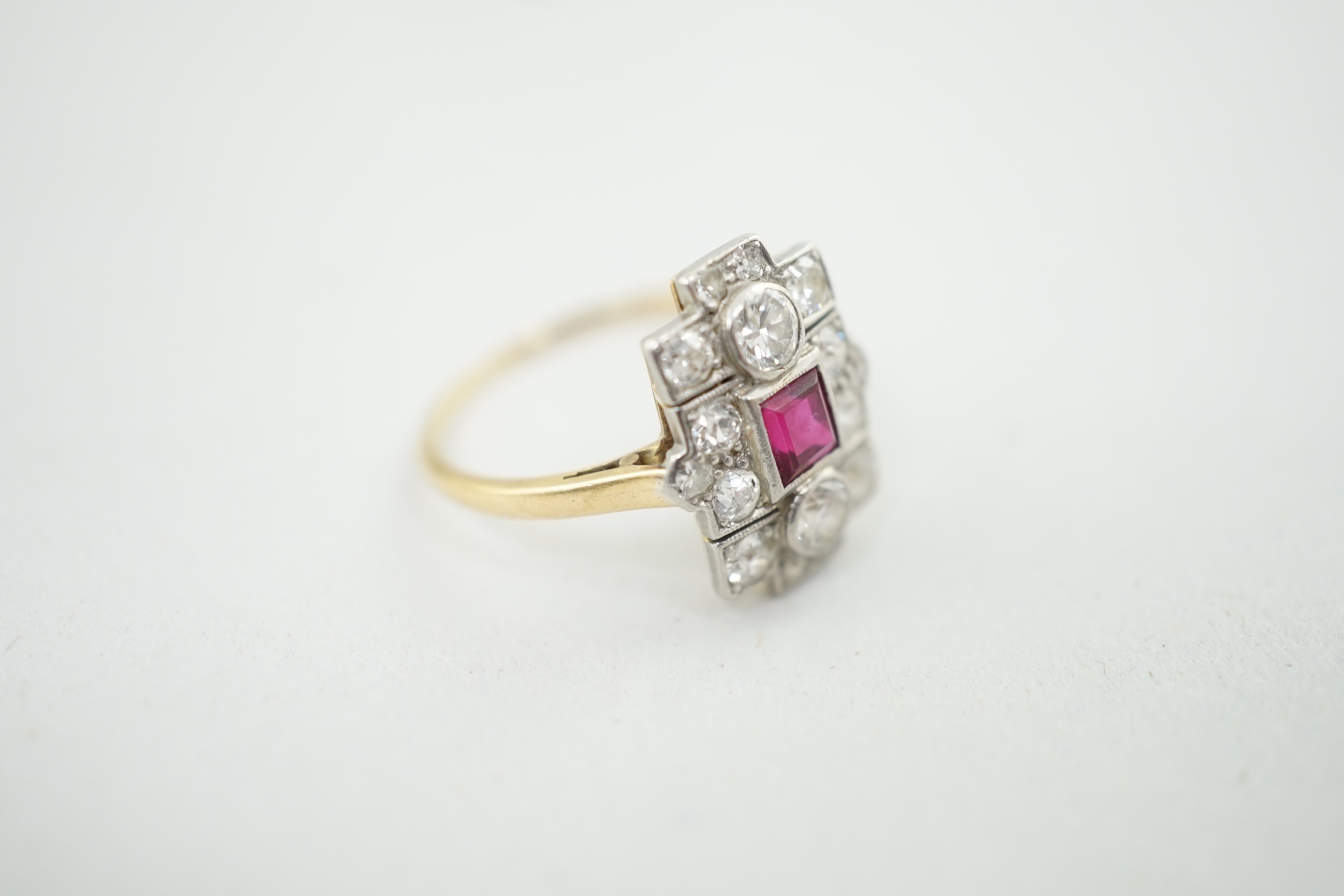 A 1920's gold and millegrain set ruby and diamond cluster dress ring